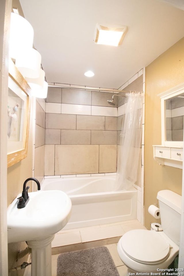 bathroom with tile patterned flooring, toilet, and shower / bath combo with shower curtain