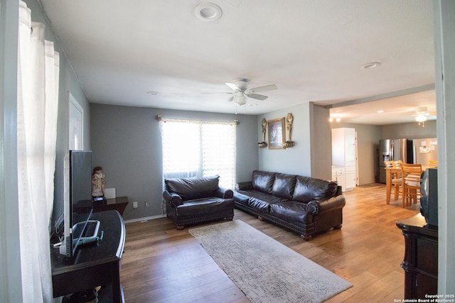 living room with hardwood / wood-style flooring and ceiling fan