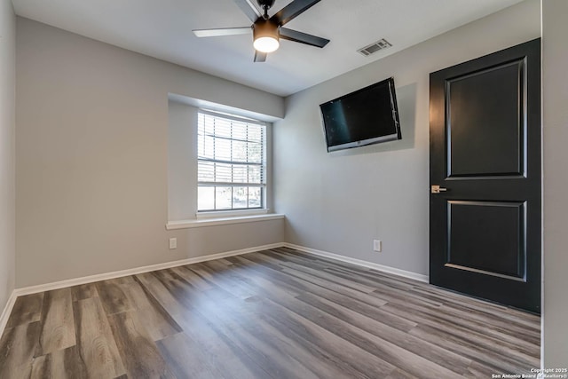 spare room with ceiling fan and light hardwood / wood-style floors