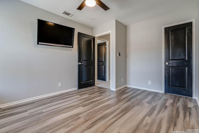 unfurnished bedroom with light wood-type flooring and ceiling fan