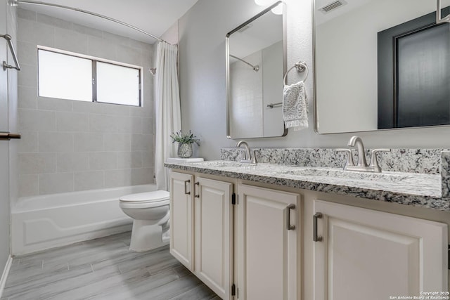 full bathroom with vanity, hardwood / wood-style flooring, toilet, and shower / bathtub combination with curtain