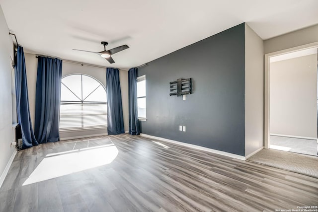 empty room featuring hardwood / wood-style flooring and ceiling fan