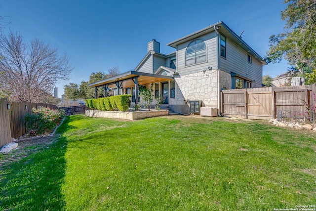 rear view of house with a yard