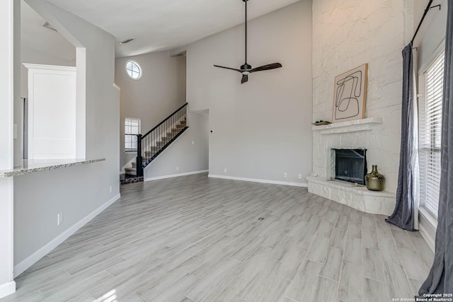 unfurnished living room with a healthy amount of sunlight, a fireplace, and light hardwood / wood-style flooring