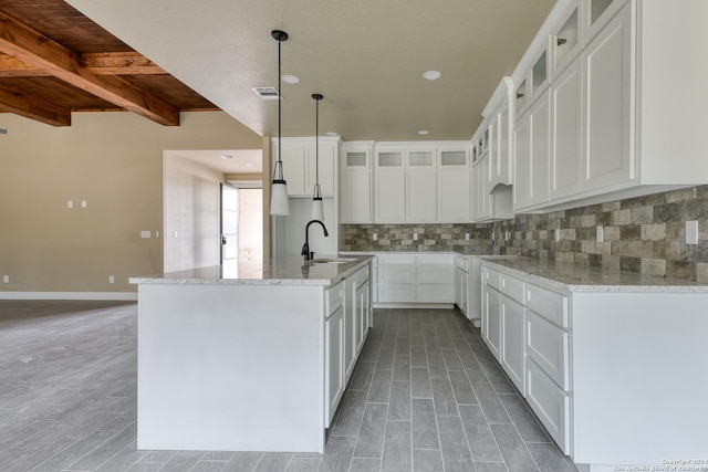 kitchen with white cabinetry, sink, and backsplash