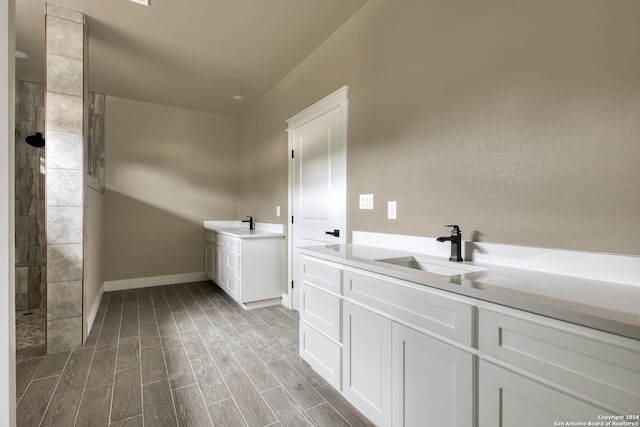 bathroom featuring walk in shower and vanity