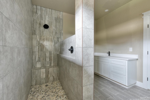 bathroom featuring vanity and tiled shower