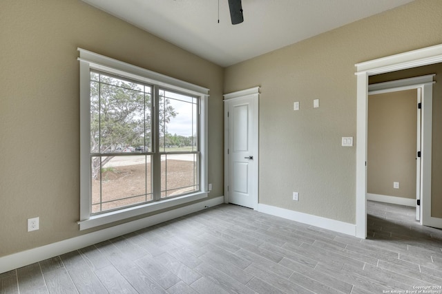 unfurnished room with ceiling fan and light hardwood / wood-style flooring