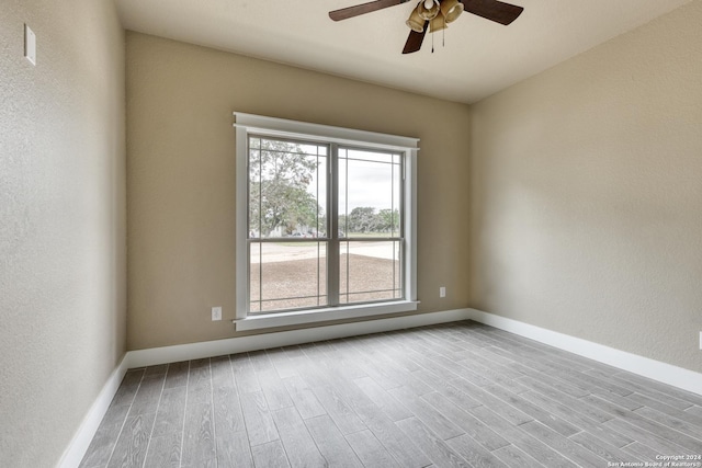 unfurnished room with ceiling fan and light wood-type flooring