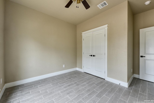 unfurnished bedroom featuring light hardwood / wood-style flooring, a closet, and ceiling fan