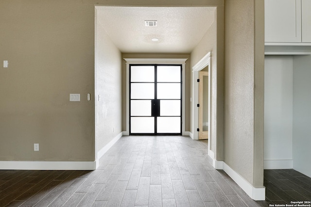 doorway featuring a textured ceiling