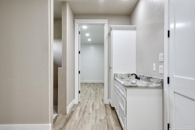 bathroom with vanity and wood-type flooring