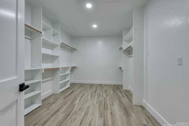 spacious closet with light hardwood / wood-style floors