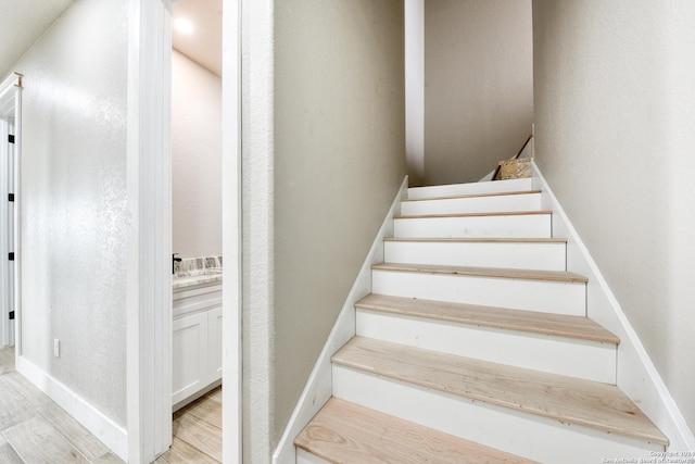 stairway featuring hardwood / wood-style flooring