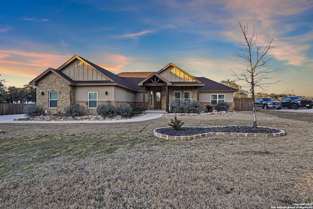 craftsman-style home with a yard