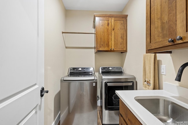 washroom featuring cabinets, washing machine and dryer, and sink