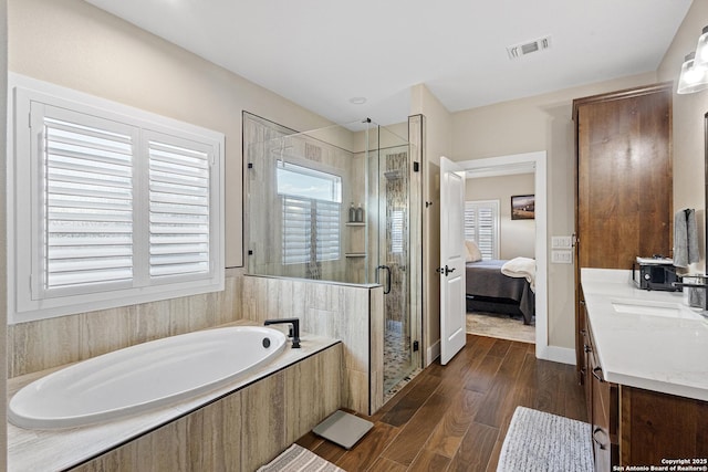 bathroom with vanity, hardwood / wood-style flooring, and independent shower and bath