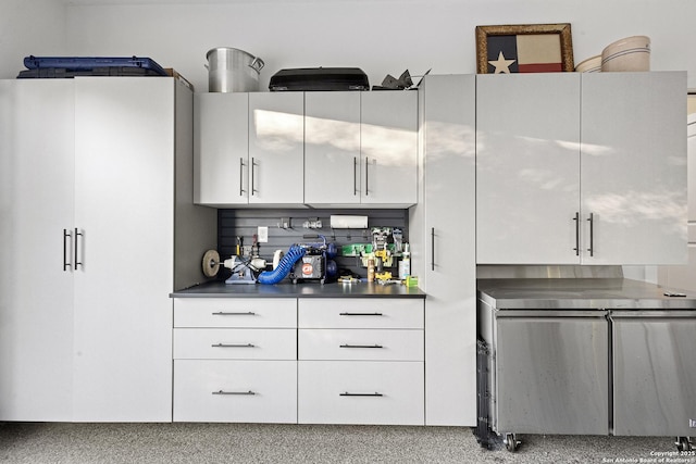 kitchen with white cabinetry and refrigerator