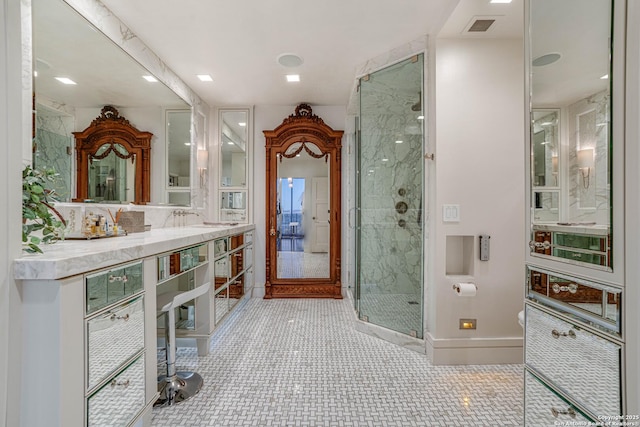 bathroom featuring an enclosed shower, sink, and tile patterned floors