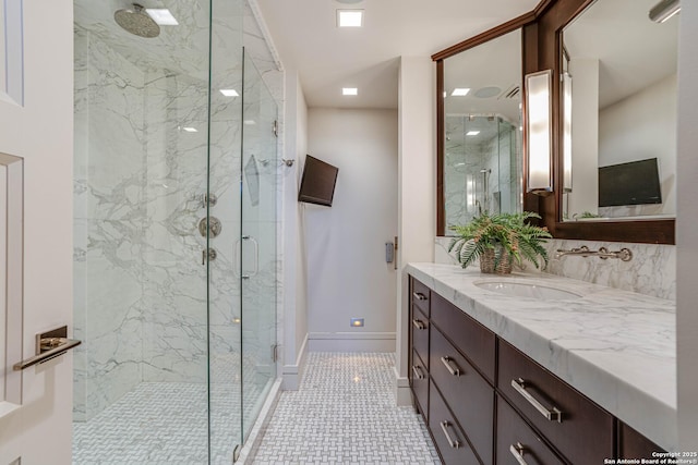 bathroom with tile patterned flooring, vanity, and a shower with door