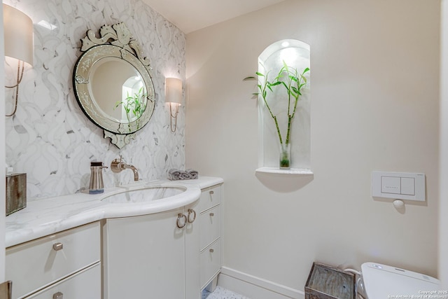 bathroom featuring vanity and toilet