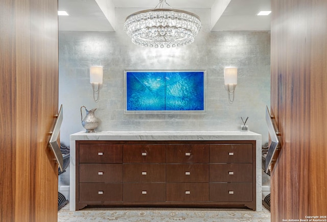 bathroom with a chandelier