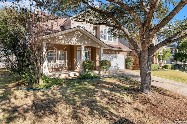 view of front facade with a garage, covered porch, and a front yard