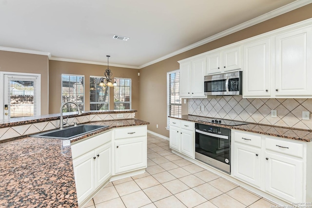 kitchen with sink, backsplash, stainless steel appliances, and white cabinets