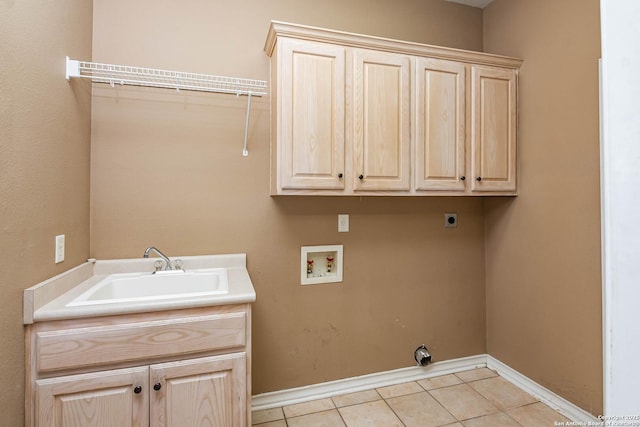 clothes washing area with sink, light tile patterned floors, hookup for a washing machine, cabinets, and hookup for an electric dryer