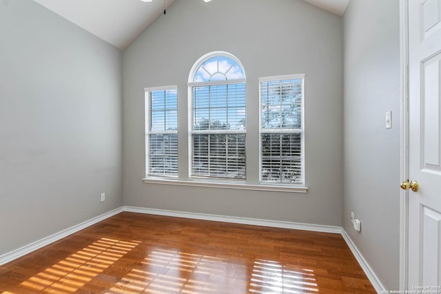 unfurnished room featuring hardwood / wood-style flooring and vaulted ceiling