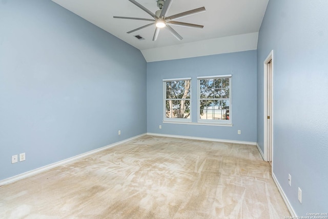 carpeted empty room featuring vaulted ceiling and ceiling fan