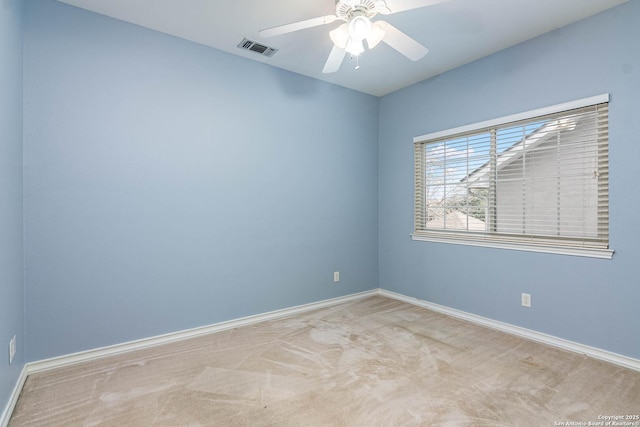 spare room featuring ceiling fan and light carpet