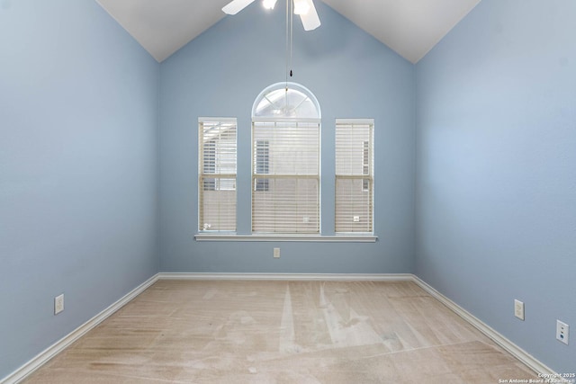 carpeted empty room featuring ceiling fan and high vaulted ceiling