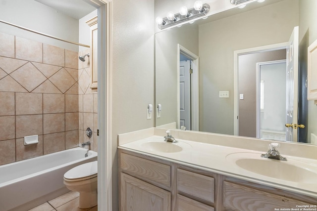 full bathroom featuring vanity, tiled shower / bath, tile patterned flooring, and toilet