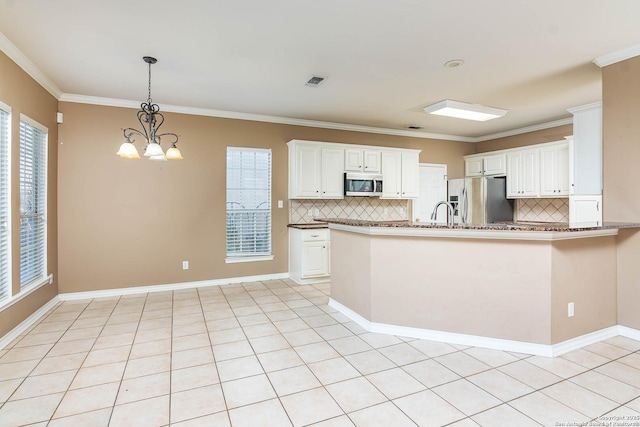 kitchen featuring white cabinetry, crown molding, appliances with stainless steel finishes, kitchen peninsula, and backsplash