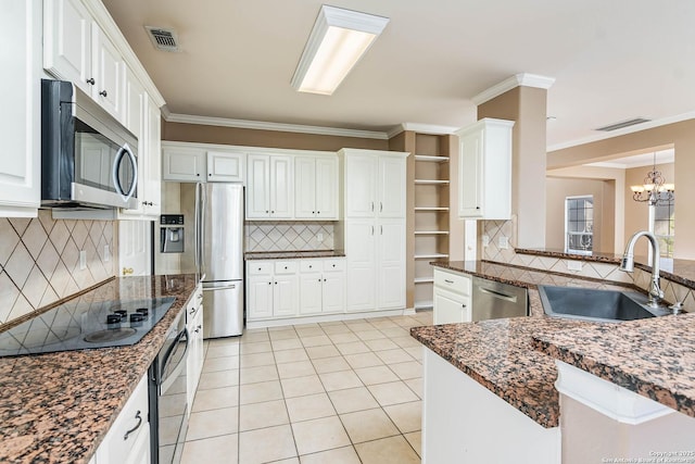 kitchen with stainless steel appliances, white cabinetry, sink, and decorative backsplash