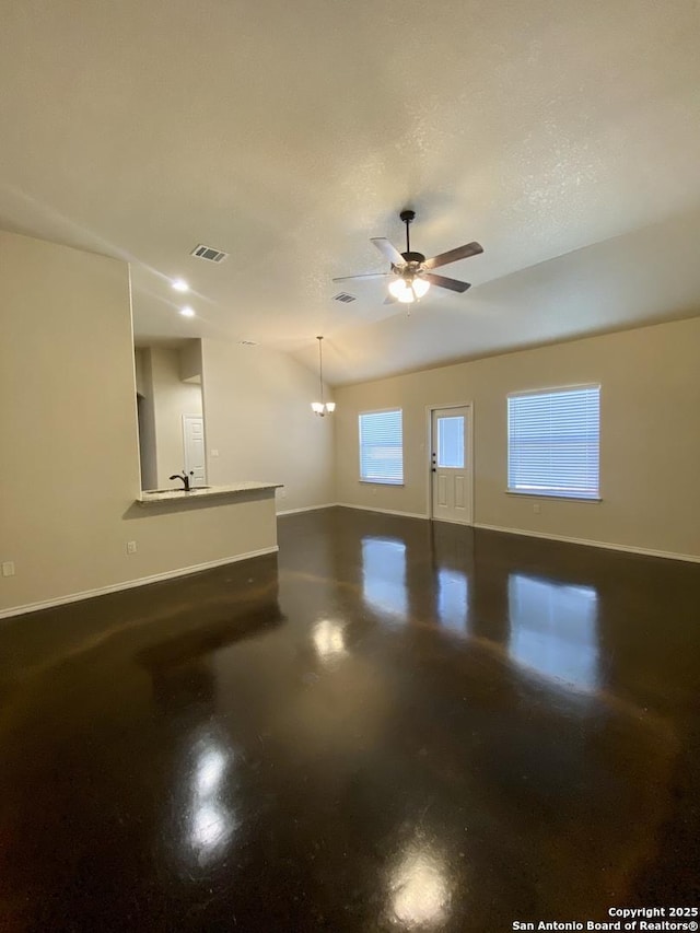 unfurnished room featuring ceiling fan, concrete flooring, and sink