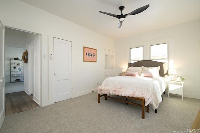 bedroom with ceiling fan, baseboards, and carpet flooring