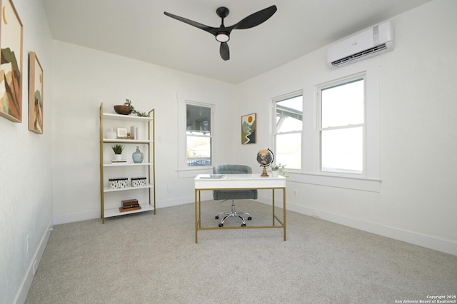 office area featuring baseboards, an AC wall unit, a ceiling fan, and light colored carpet