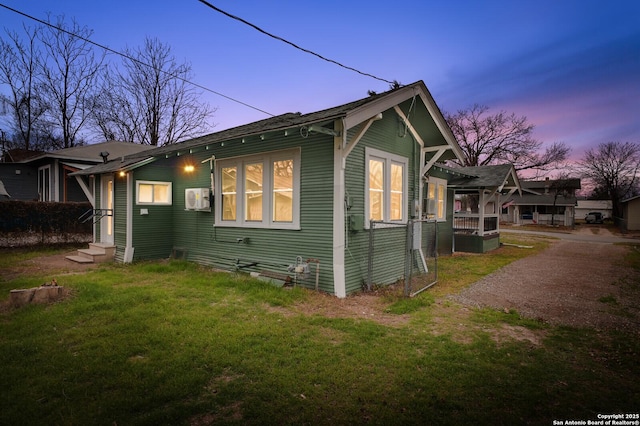 view of home's exterior with entry steps and a yard