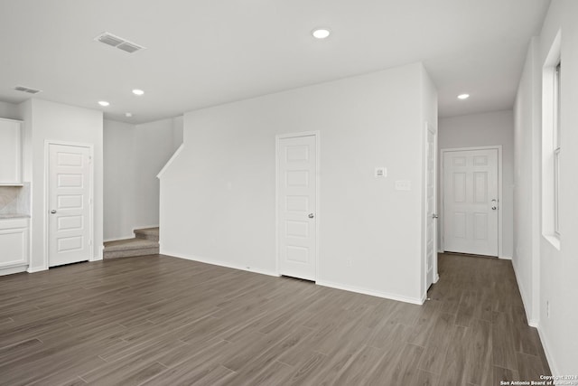 unfurnished living room with dark hardwood / wood-style floors