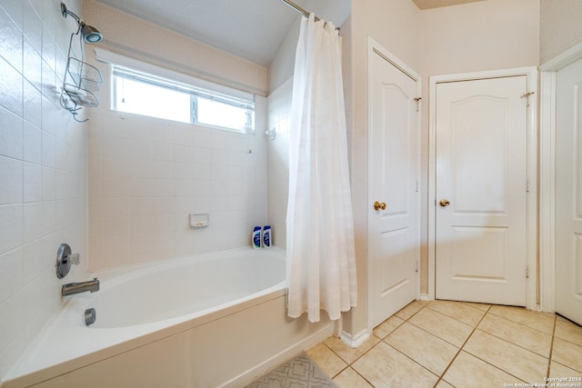 bathroom with tile patterned flooring and shower / bathtub combination with curtain