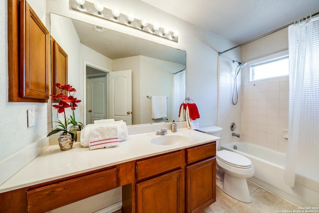 full bathroom featuring vanity, tile patterned floors, toilet, and shower / bath combo with shower curtain