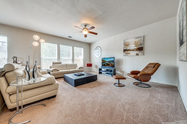 living room featuring plenty of natural light, a textured ceiling, and carpet flooring