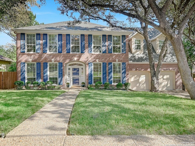 colonial-style house with a garage and a front lawn