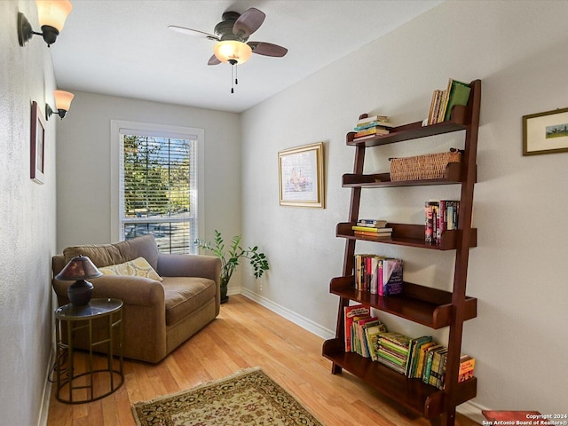 living area with ceiling fan and light wood-type flooring