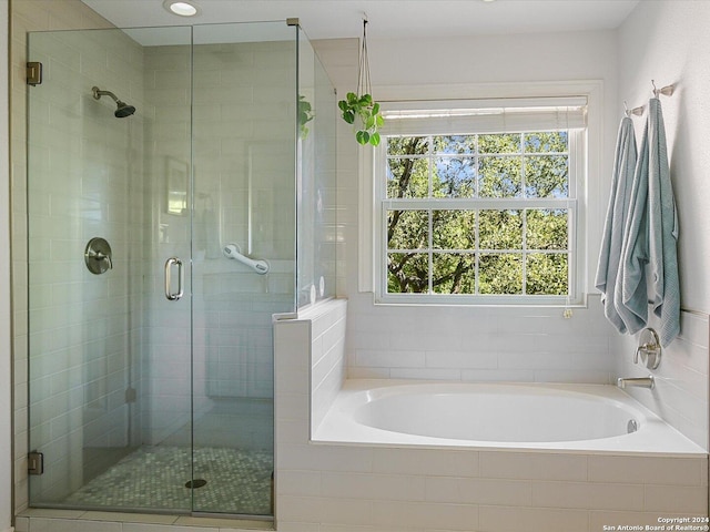 bathroom with shower with separate bathtub