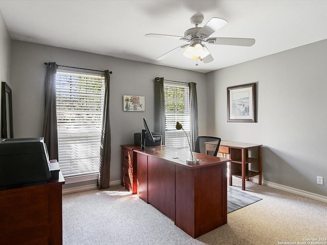 carpeted home office featuring ceiling fan and a healthy amount of sunlight