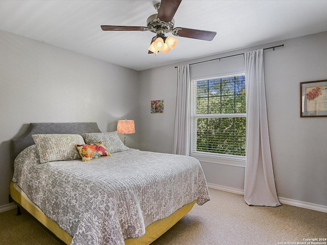 bedroom featuring ceiling fan and carpet