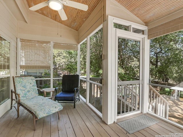 sunroom / solarium featuring wood ceiling, ceiling fan, and vaulted ceiling